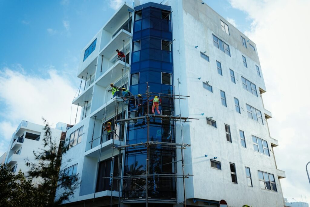 Construction crew working on a modern building facade